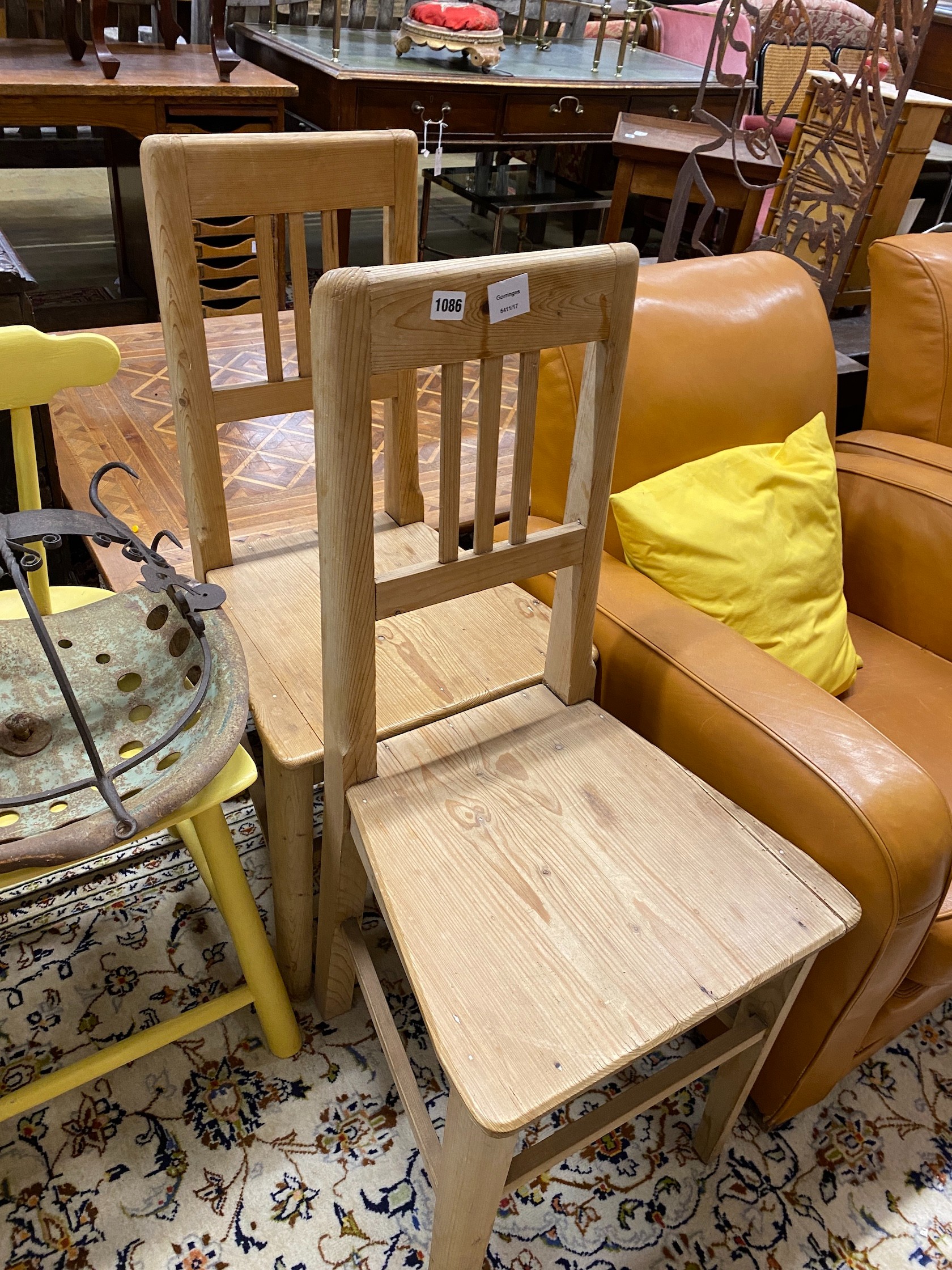 A pair of provincial pine chairs, one other, a pot hanger and vintage tractor seat